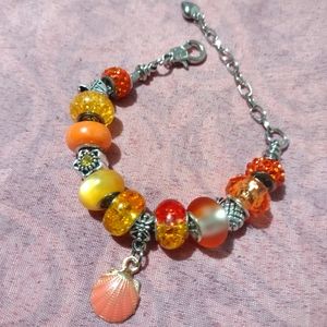 Silver snake chain charm bracelet with orange European beads and silver spacers